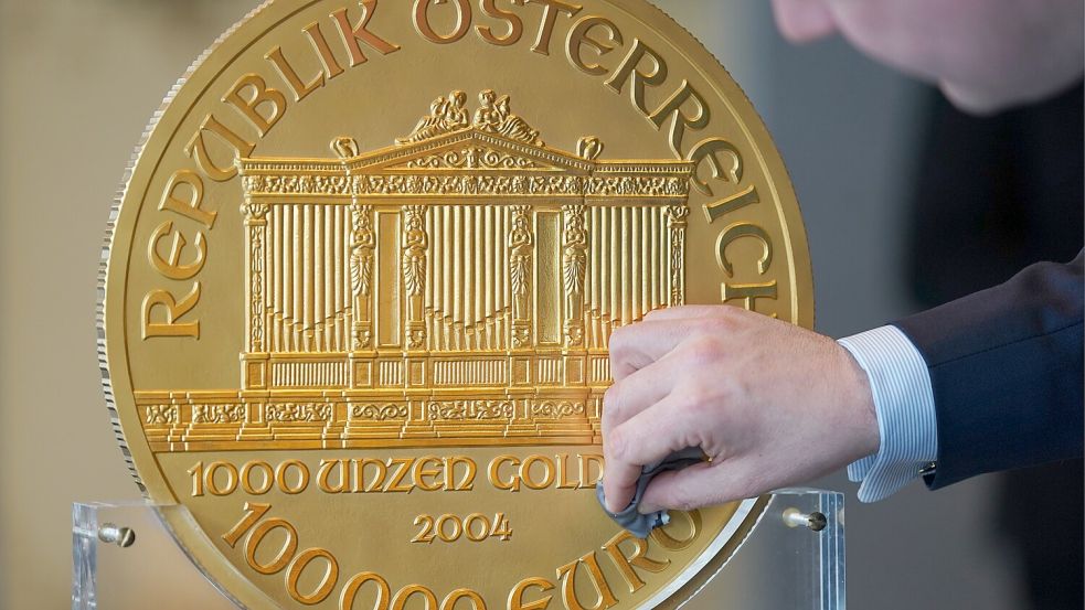 Glanz für das Goldstück: Alexander Köhne, Vertriebsleiter von Pro Aurum, wienert die Rekordmünze. Foto: Marcus Brandt/dpa