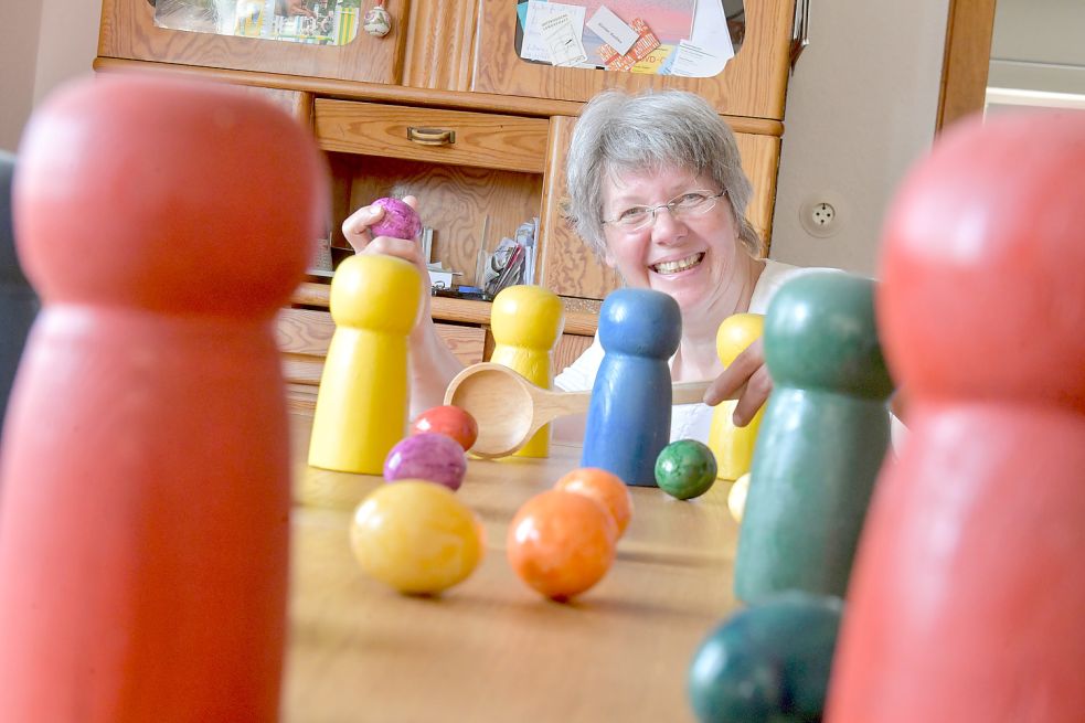 Zwischen Mensch-Ärgere-Dich-Nicht-Figuren trüllt Christine Schneider-Berents ihre Ostereier. Bild: Ortgies