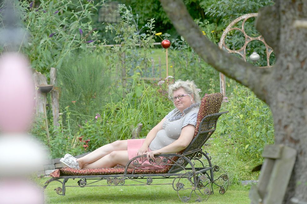 Ein Garten zum Wohlfühlen ist neben dem alten Haus entstanden. Dazu passen die alten Eisenfenster, von denen eines hier im Hintergrund zu sehen ist. Foto: Ortgies