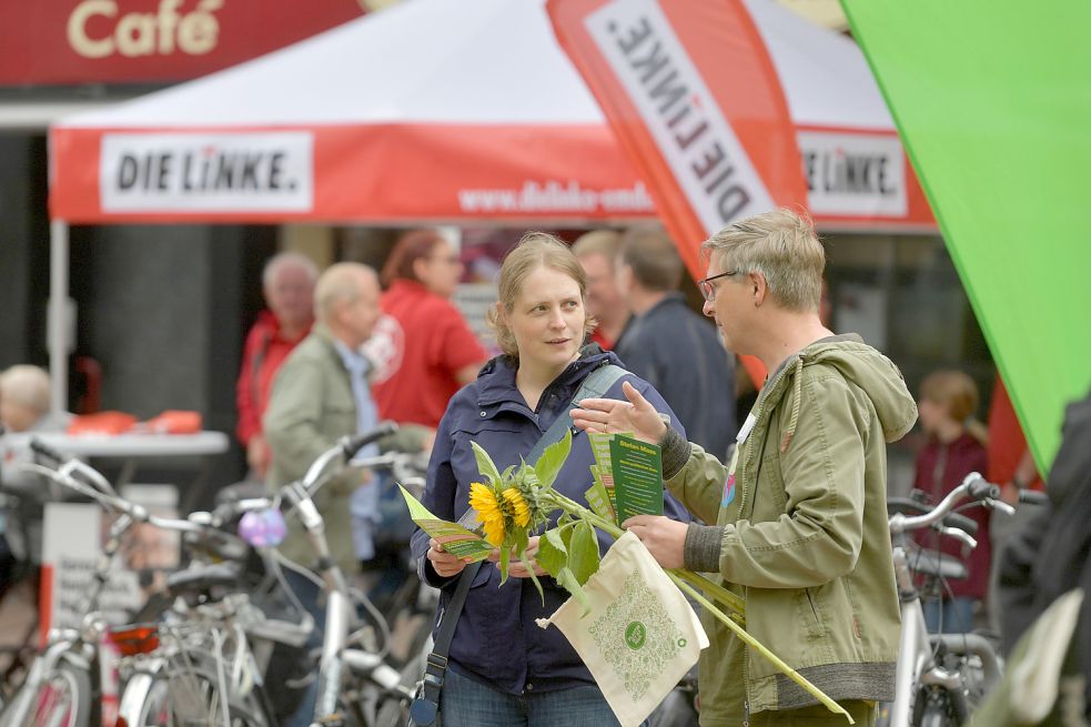 Vorne Grün und hinten Rot: Anke Klostermann hört am Wahlstand der Grünen Andreas Kalkwarf zu. Hinter ihrem Rücken möchte auch die Linke gerne ins Gespräch kommen. Foto: Ortgies