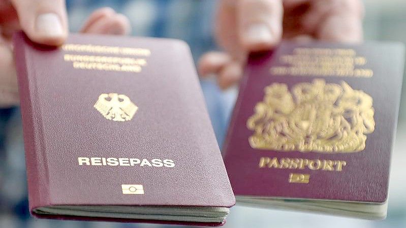 Ein britischer und ein deutscher Reisepass. Bis auf wenige Ausnahmen reicht ab dem 01.10.2021 an ein Personalausweis nicht mehr aus, um in Großbritannien zu kommen. Foto: Britta Pedersen/zb/dpa