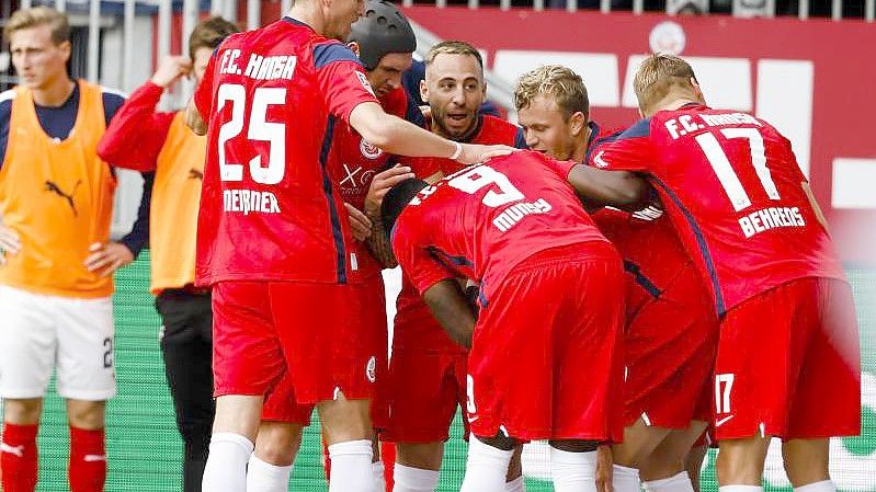 Rostocks Spieler jubeln nach dem 2:0 für Hansa im Ostsee-Duell mit Holstein Kiel. Foto: Frank Molter/dpa