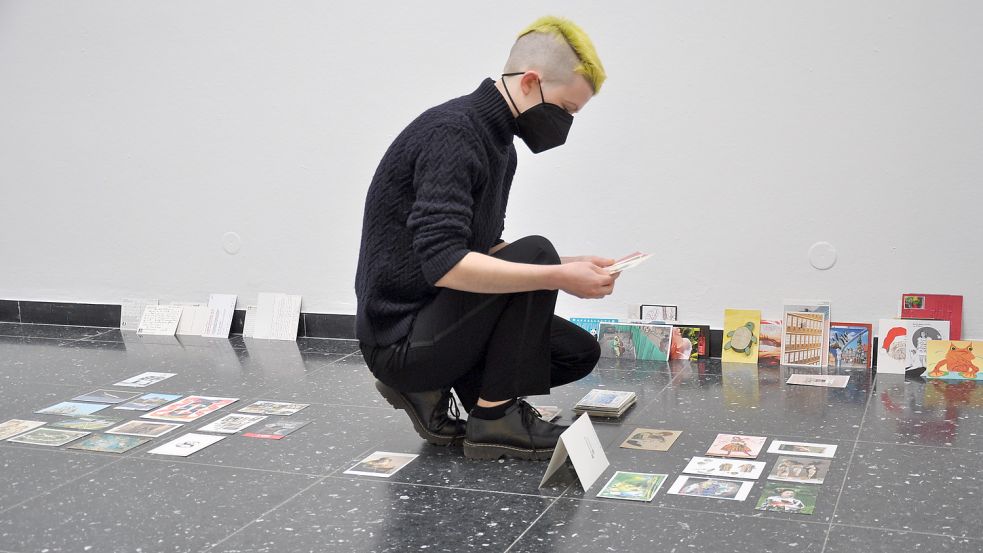 Eddi de Goër arrangiert ihre Arbeit. Im Verlauf der Nordwestkunst wird sie die Postkarten neu aufstellen, kündigt Kunsthallenleiterin Petra Stegmann an. Foto: Ullrich