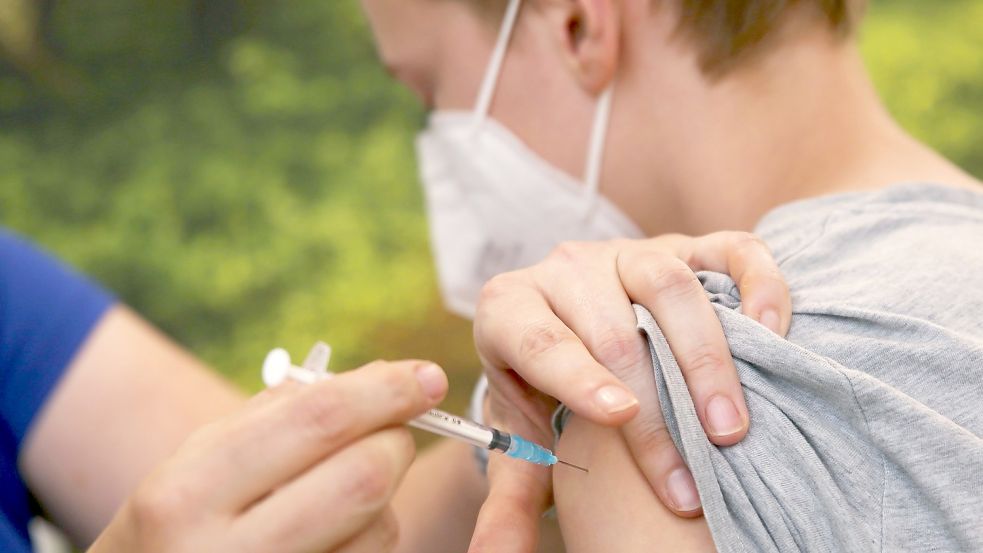 Eine Kinderärztin impft einen Jungen mit dem Corona-Impfstoff Comirnaty von Biontech-Pfizer. Foto: David Young / dpa