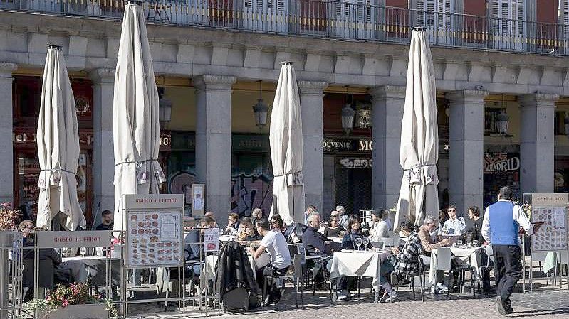 Kunden sitzen auf einer Terrasse in Madrid. In Spanien ist die Corona-Lage derzeit entspannt. Foto: A. Pérez Meca/EUROPA PRESS/dpa