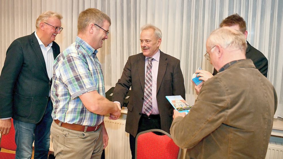 Samtgemeindebürgermeister Uwe Themann (Mitte) und der Allgemeine Vertreter Joachim Duin (verdeckt) verpflichteten alle neuen Ratsmitglieder, hier (von links) Johannes Poppen (AWG), Erwin Burlager (AWG) und Bernhard Janssen (AWG). Foto: Stromann