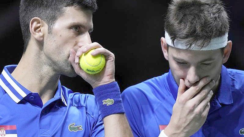 Hat das Doppel gegen Kroatien verloren: Der Serbe Novak Djokovic (l) flüstert mit seinem Teamkollegen Filip Krajnovic. Foto: Bernat Armangue/AP/dpa