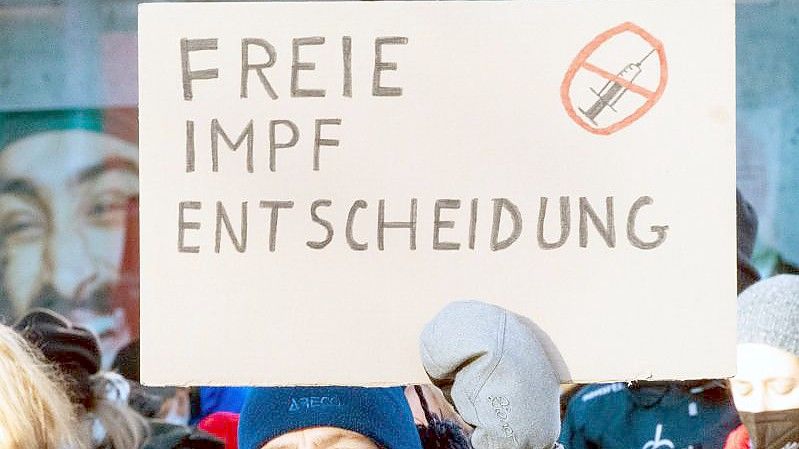 Menschen demonstrieren gegen die Impfpflicht und Maßnahmen zur Eindämmung der Coronapandemie. Foto: Christophe Gateau/dpa