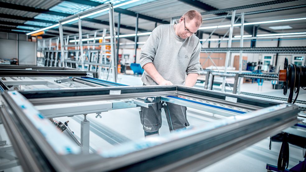 Mitarbeiter Tobias Harbers montiert in der neuen Produktionshalle Fensterrahmen. Foto: Cordsen