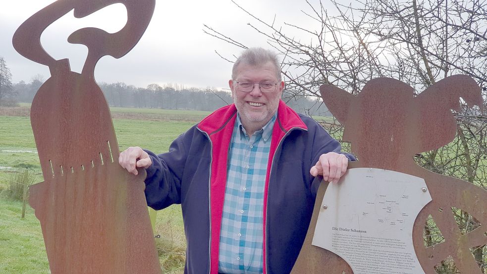 Ortsvorsteher Hinrich Sap, steht neben den Stahlstelen beim Feuerwehrhaus in Diele. Die Figuren erinnern an den Fürstbischof von Münster, Christoph Bernhard von Galen, bekannt als „Bomben-Bernd“. Kanonenkugeln der Kämpfe wurden auf den Dielen Schanzen gefunden. Foto: Gettkowski