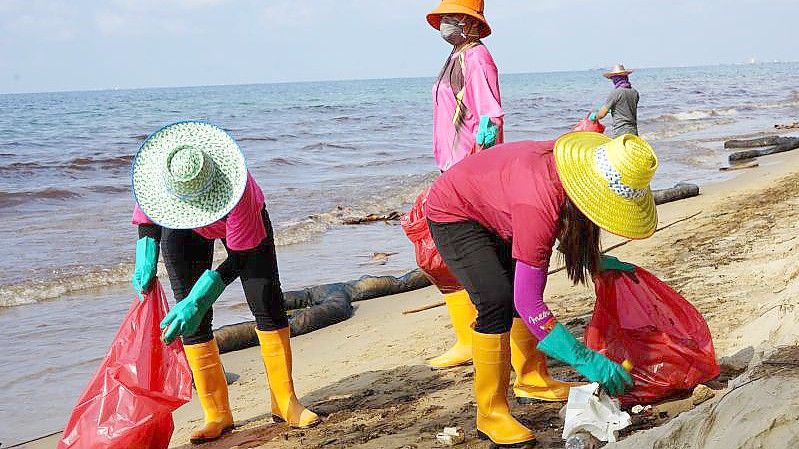 Am Strand Mae Ramphueng in der Provinz Rayon wird mit Öl verschmutztes Material eingesammelt. Foto: Athens Zaw Zaw/dpa
