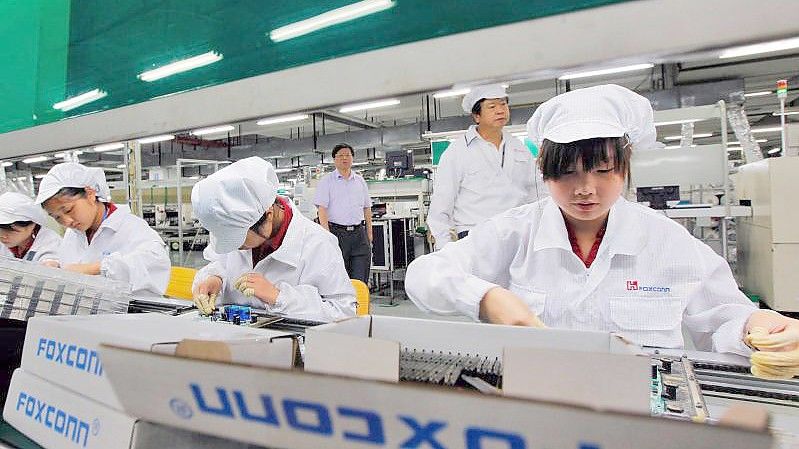 Chinesische Mitarbeiter des Apple-Zulieferers Foxconn arbeiten im Lunghua-Werk. Foto: Ym Yik/epa/dpa