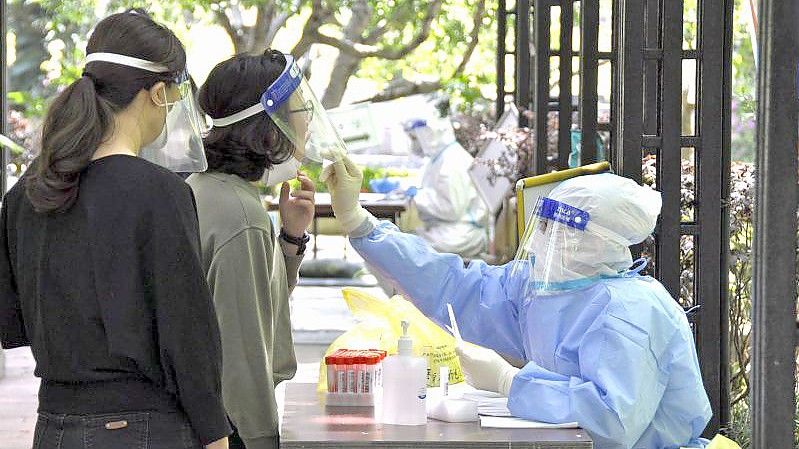 Bewohnerinnen einer Wohnanlage in Shanghai bei einem PCR-Test. Die Corona-Zahlen in der chinesischen Millionenmetropole bleiben trotz Lockdown hoch. Foto: -/kyodo/dpa