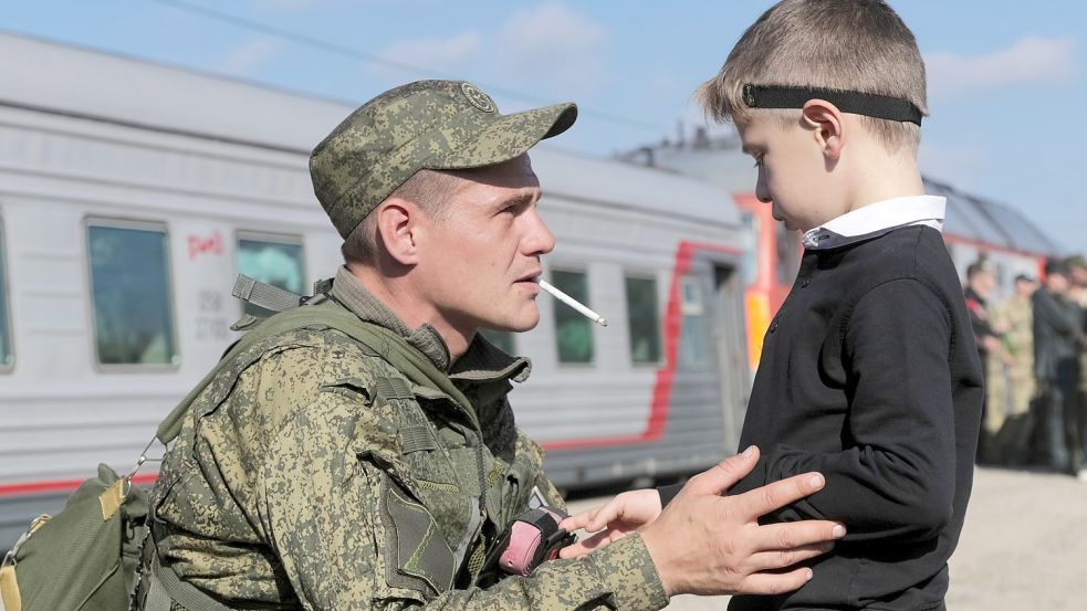 Abschied auf Nimmerwiedersehen? Ein russischer Soldat zieht an die Front. Die imperiale Politik von Präsident Wladimir Putin macht Kinder zu Waisen. Foto: Picture Alliance/AP/DPA
