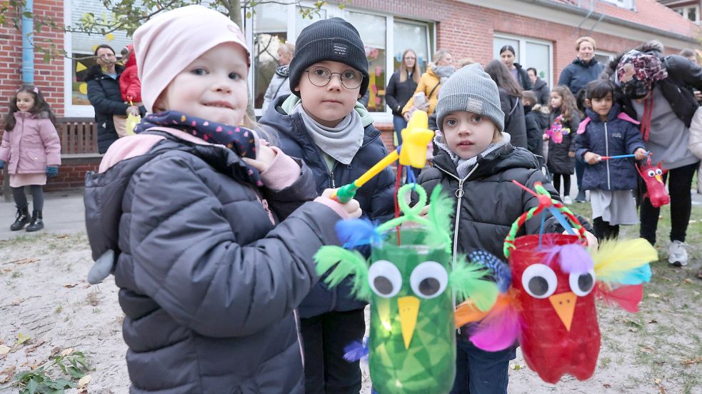 Viele Eulen gibt es dieses Martini im Kindergarten Neue Heimat. Kinder haben die Laternen mit Kulleraugen und Federn beschmückt. Das Bild zeigt (von links) Sophie Schumann mit Yunes und Niya Carstens. Foto: Päschel