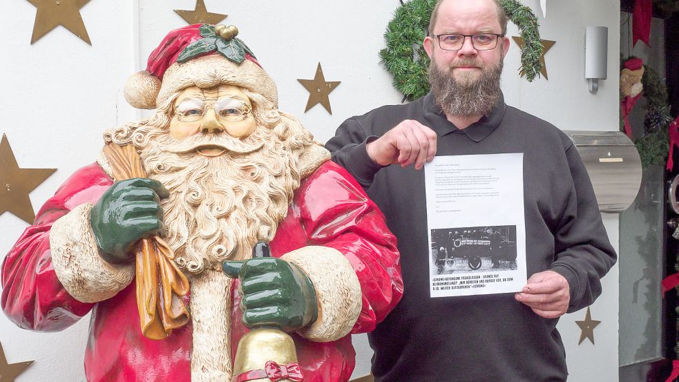 Sven Borchart mit dem Drohbrief: Der Weihnachtshausbesitzer hat bei der Polizei bereits Anzeige gestellt. Foto: AleX/PHOTO