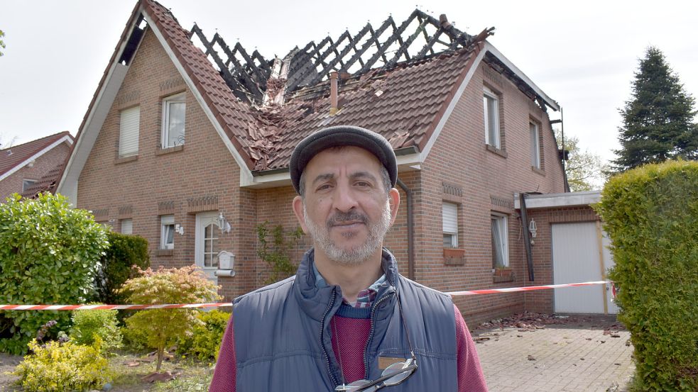 Der Rhaudermoorer Hussam Ashlak steht vor seiner Doppelhaushälfte, die in der Nacht zu Dienstag durch ein Feuer zerstört wurde. Foto: Zein