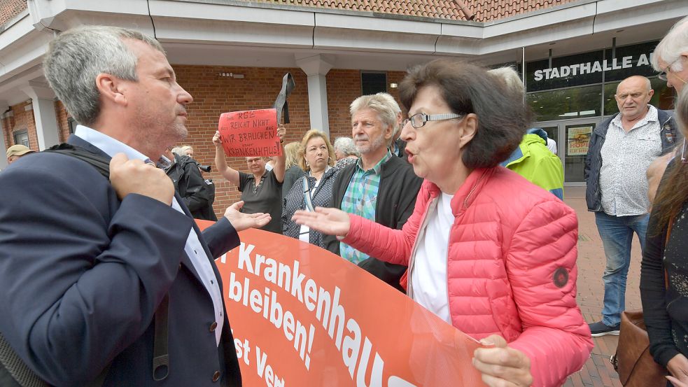 Schon vor der Kreistagssitzung machten viele Bürger ihrem Ärger Luft. Hier diskutiert Regina Körholz mit dem Bundestagsabgeordneten und Kreistagsmitglied Johann Saathoff (SPD, Pewsum). Foto: Ortgies