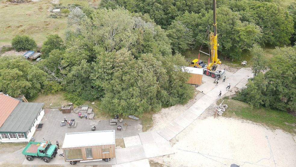 Auf dem Internatsgelände wurden Metallplatten ausgelegt. Ein Kran setzt die Tiny Häuser auf die dafür vorgesehenen Fundamente. Foto: Langner