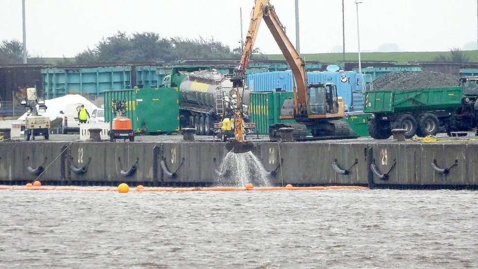 Noch bei der Arbeit: Der Langarmbagger am Südkai, der 1100 Tonnen Splitt aus dem in elf Metern Tiefe liegenden Schiffswrack holt. Foto: F. Doden