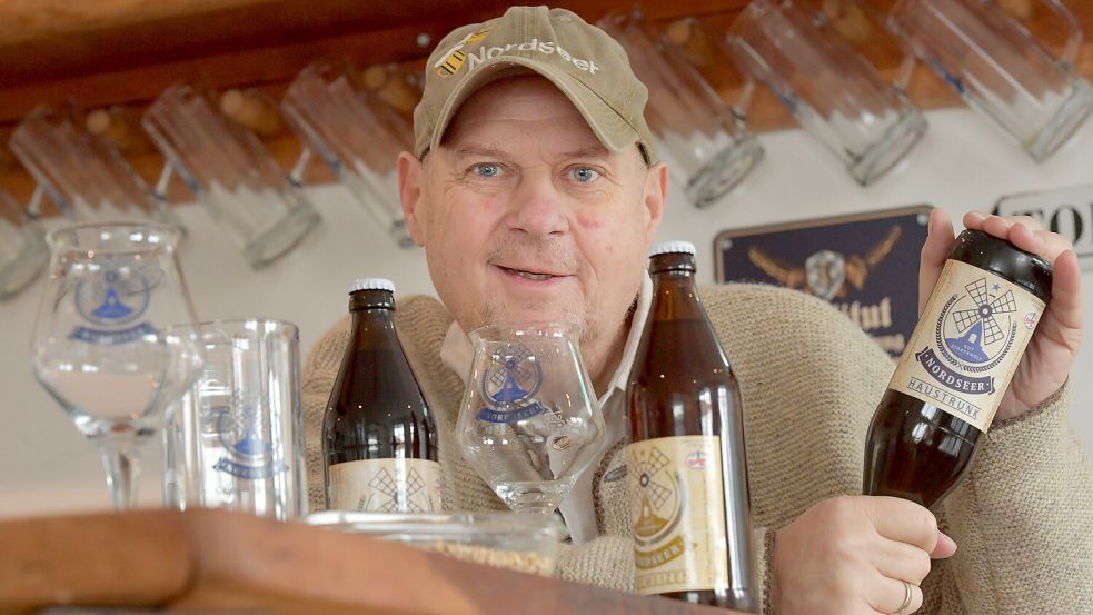 Robert Jacobs mit dem Haustrunk der Marke Nordseer Bier im Braustüberl. Das Bier ist ungefiltert, deshalb muss die Flasche vor dem Trinken mindestens einmal auf dem Kopf stehen. Foto: Ortgies