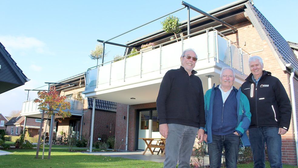 Hans Ludwig Janssen, Günther Meidenbauer und Jan Denkena (von links) vor ihrem nagelneuen Haus in Wittmund. Der vierte Eigentümer ist nicht im Bild. Foto: Oltmanns