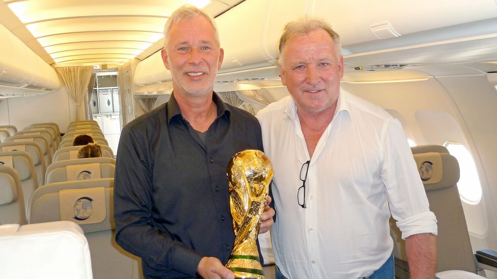 In Berlin stellten Edgar Ludwigs und Andreas Brehme im Juni 2020 in einer Bundeswehr-Maschine das Bild von 1990 nach. Mit einer WM-Pokal-Kopie. Foto: Privat