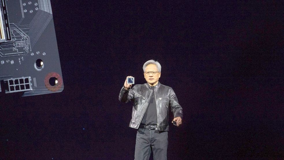 Jensen Huang, Chef des Chipkonzerns Nvidia, zeigt auf der hauseigenen Entwicklerkonferenz GTC den neuen KI-Chip Blackwell. Der Chipkonzern will die führende Rolle bei Technik für Anwendungen mit Künstlicher Intelligenz ausbauen. Foto: Andrej Sokolow/dpa