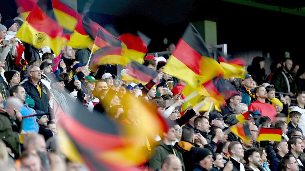 Fans feuern die deutsche Mannschaft an. Auf der Freilichtbühne in Wiesmoor kann während der Spiele der Deutschen im Juni live mitgefiebert und mitgefeiert werden. Foto: Dedert/dpa