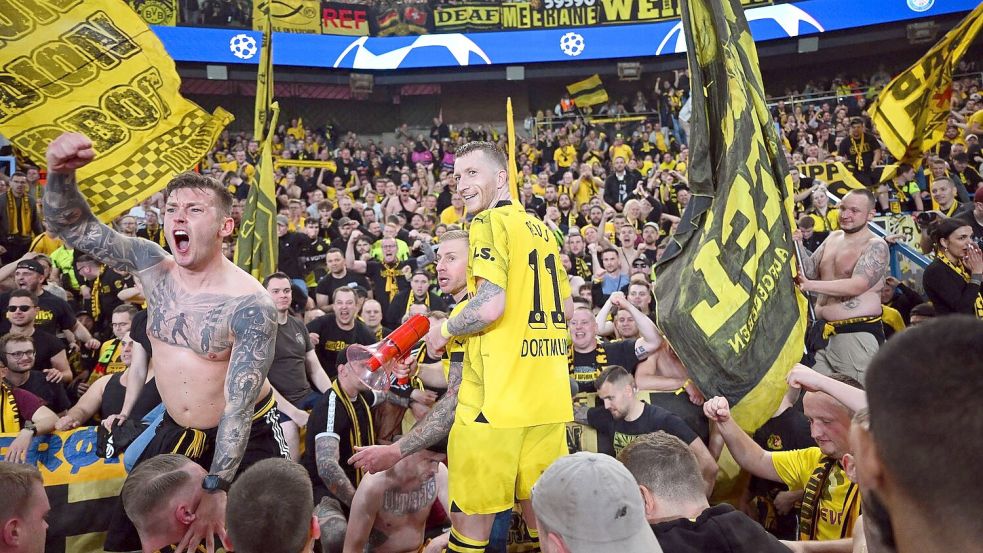 Dortmunds Marco Reus (M) jubelt mit den mitgereisten Fans über den Einzug ins Champions-League-Finale. Foto: Robert Michael/dpa