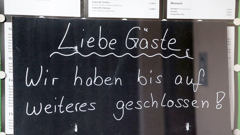 „Wir haben bis auf Weiteres geschlossen!“ steht auf einem Schild in der Vitrine eines Restaurants. Symbolfoto: Archiv/Friso Gentsch/dpa