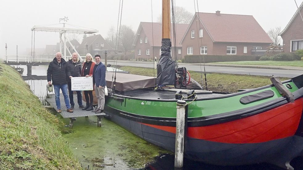Frank Schoone (von links), Fachgruppenleiter „Bautechnik“ Günther Siefken, Grete Tornow vom Kultur und Heimatverein Großefehn sowie Jelto Müller, Geschäftsführer der Wirtschaftsförderung des Landkreises Aurich, trafen sich am Anleger der „Frauke“ zur Übergabe eines Präsentationsschecks in Höhe von 3000 Euro. Foto: privat