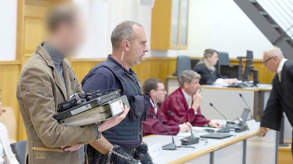 Ein Mitglied der „Vereinten Patrioten“ wird in Handschellen in den Gerichtssaal geführt. DPA-Foto: Frey
