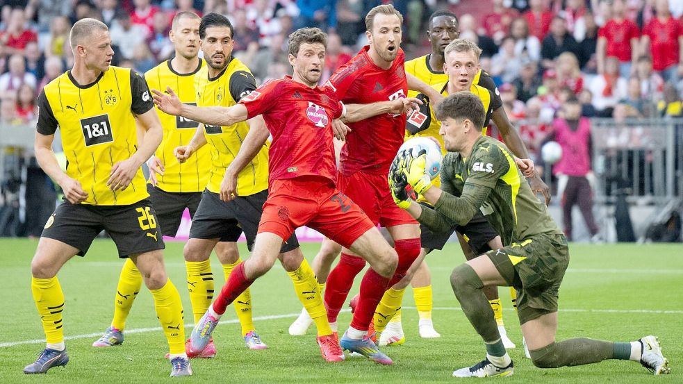 BVB-Torwart Gregor Kobel (r) packt vor Thomas Müller (m) zu. Foto: Sven Hoppe/dpa