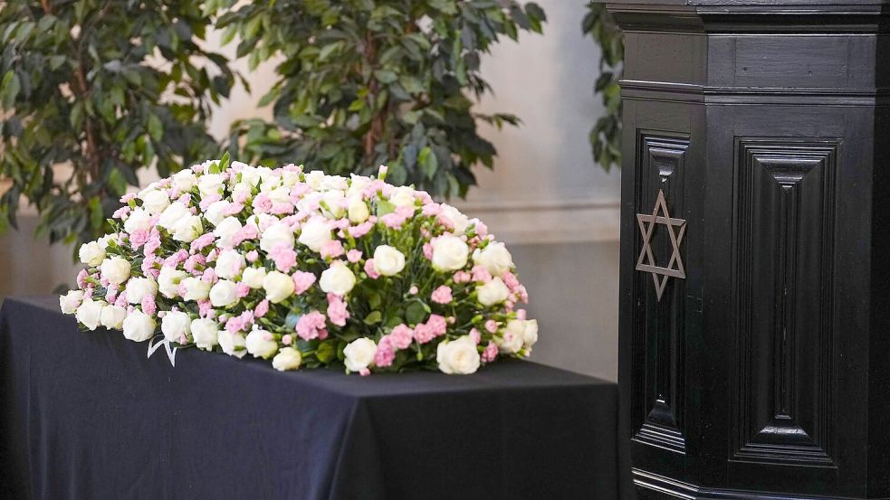 Blumen liegen auf dem Sarg Friedländers. Foto: Kay Nietfeld/dpa Pool/dpa