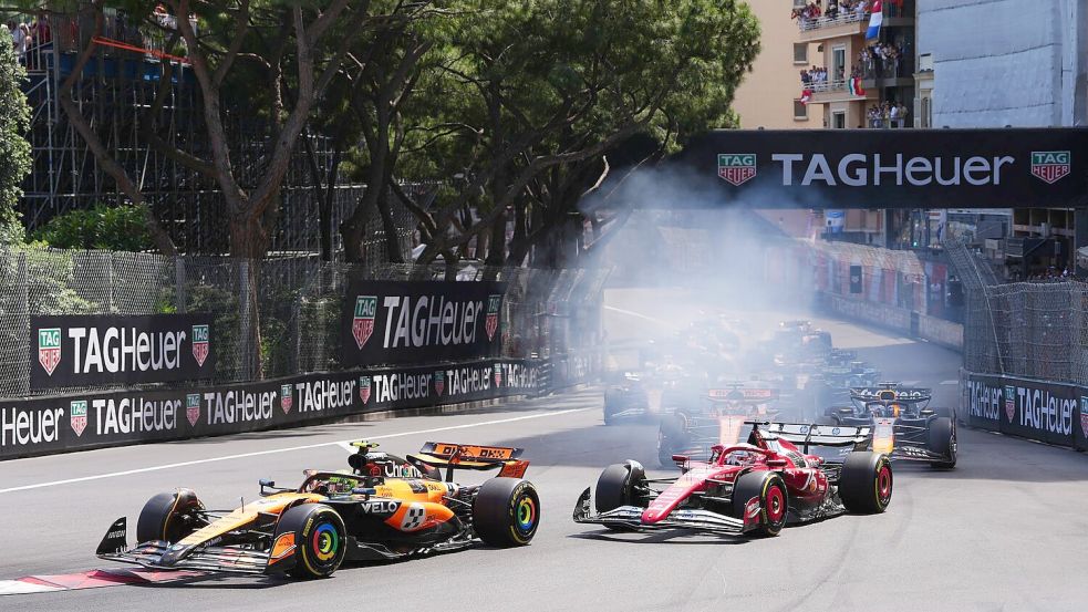 Lando Norris verteidigt in der ersten Kurve die Führung vor Charles Leclerc. Foto: David Davies/PA Wire/dpa