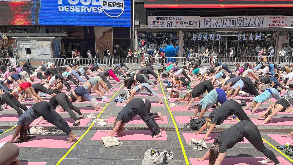 Trotz Hitzewelle versammeln sich Hunderte für Yoga auf dem Times Square. Foto: Christina Horsten/dpa