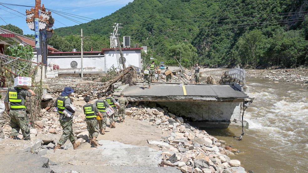 Soldaten im Bezirk Miyun am Stadtrand von Peking liefern Hilfsgüter. Die Region wurde besonders schwer getroffen. Foto: Ju Huanzong/Xinhua/AP/dpa