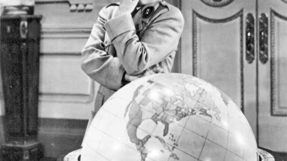 Charlie Chaplin beäugt in der Rolle des Adenoid Hynkel in der Hitler-Persiflage „Der große Diktator“ von 1940 mit irrem Blick eine Weltkugel. Die Szene, in der er mit dem Globus verspielt tanzt, ist mit Wagner-Musik unterlegt. (Archivbild) Foto: dpa