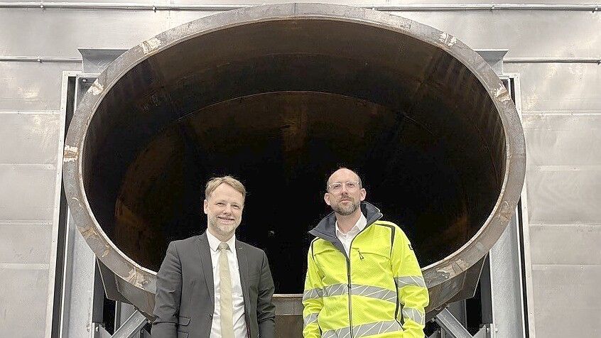 Niedersachsens Finanzminister Gerald Heere (Grüne) steht mit Stephan Rinne (rechts im Bild) vom staatlichen Baumanagement vor dem Stahltrichter der Lärmschutzhalle. Foto: Imke Oltmanns