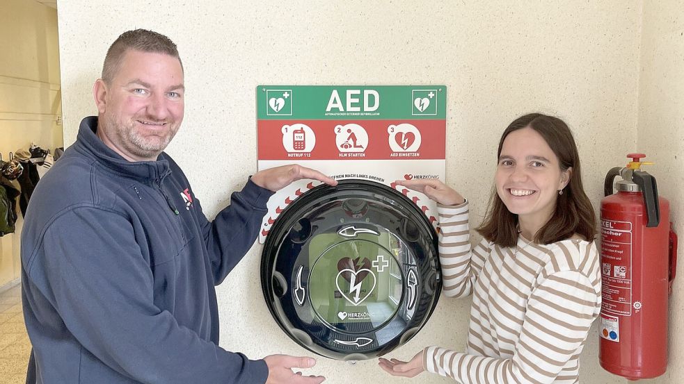 Hausmeister Harri van der Werf und Schulleiterin Julia Bredemeier präsentieren den Defibrillator. Foto: privat