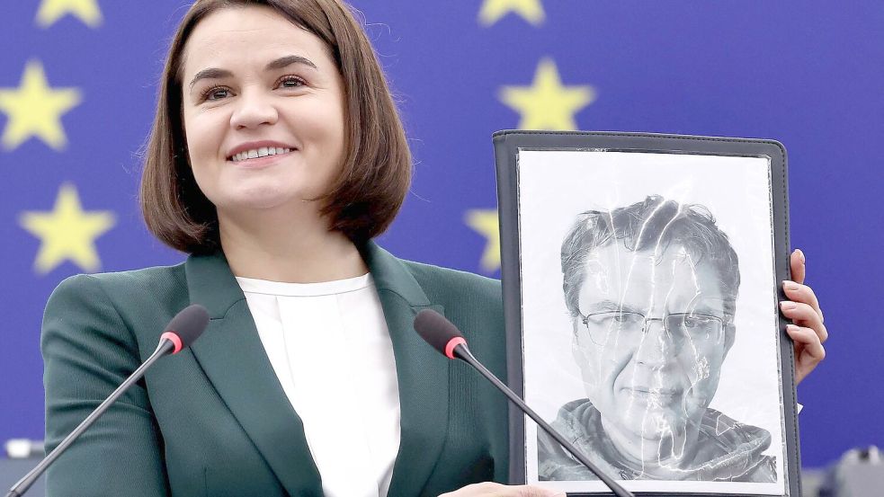Die belarussische Oppositionsführerin Swetlana Tichanowskaja zeigt ein Bild von Andrzej Poczobut. Foto: Frederick Florin/AFP/dpa