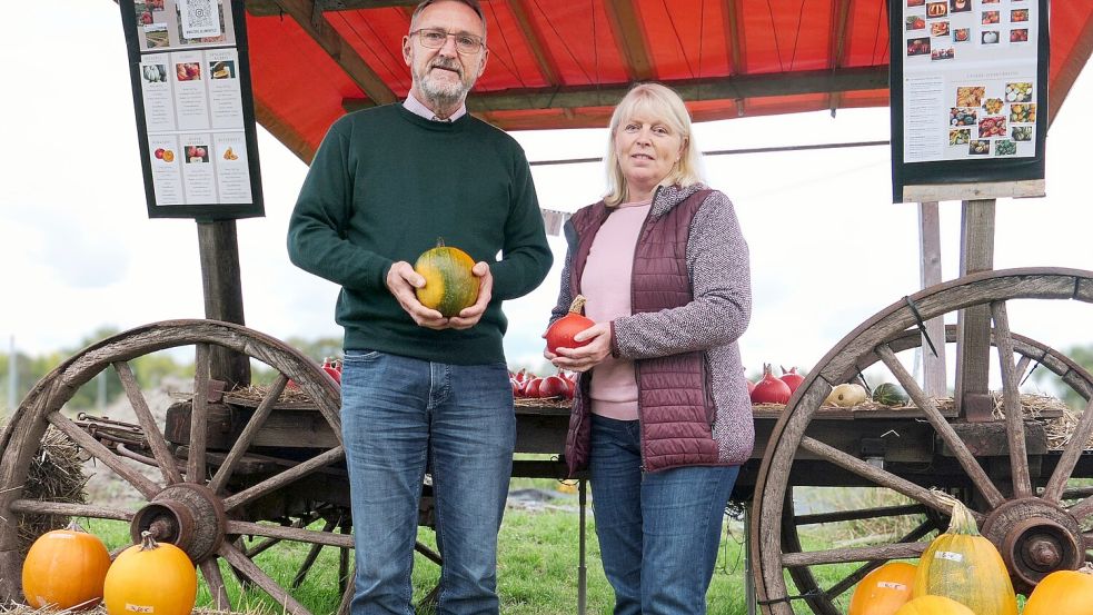 Achim und Marion Walter an ihrem Kürbiswagen, der auf seinen Schildern die verschiedenen Sorten und ihre Eigenschaften vorstellt. Foto: Christoph Beyer