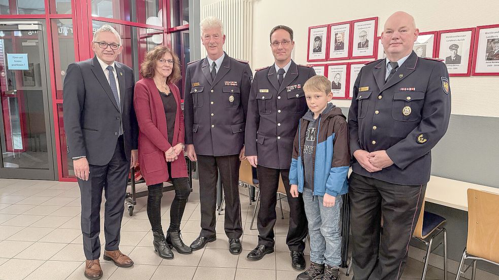 Bei der Feier zur Verabschiedung stellten sich Aurichs Landrat Olaf Meinen (von links), Alice Töpfer, Karl Töpfer, Mario Eilers mit Sohn und Kreisbrandmeister Uwe Behrends für ein Foto auf. Foto: privat