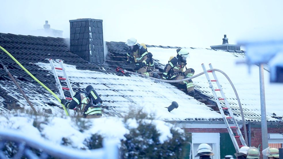 Die Einsatzkräfte mussten für die Löscharbeiten bei winterlichen Verhältnissen auf das Dach des Hauses klettern.