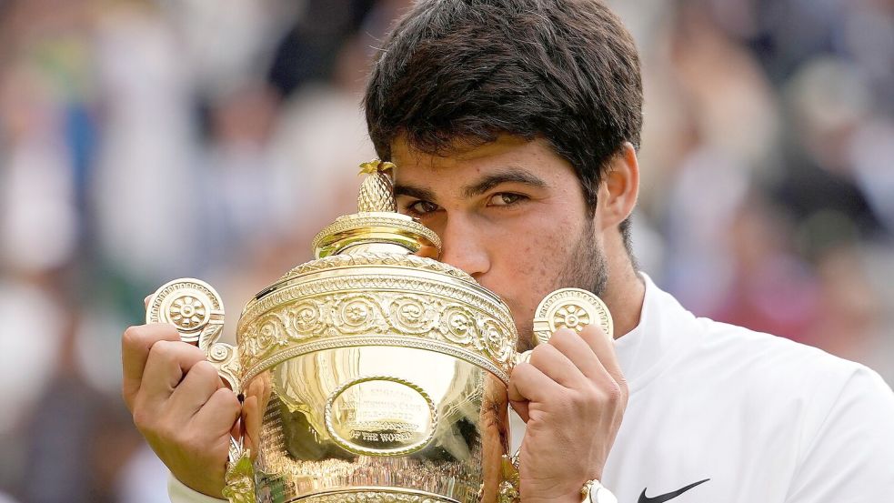 Liebkosung für den Pokal: Tennisprofi Carlos Alcaraz freute sich sichtlich über den Sieg im Wimbledon-Final 2023. (Archivbild) Foto: Kirsty Wigglesworth/AP/dpa