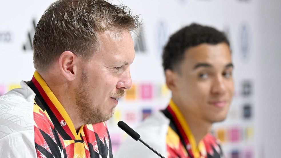Julian Nagelsmann (l.) und Jamal Musiala (r.) sprechen bei der DFB-Pressekonferenz. Foto: Federico Gambarini/dpa