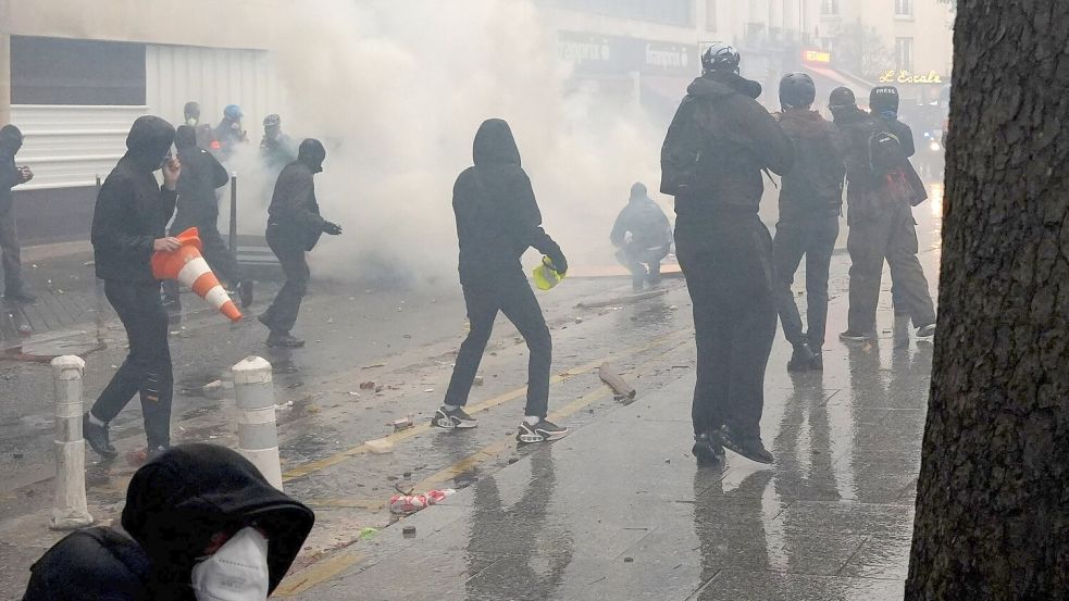 Vermummte Demonstranten liefern sich in Paris Auseinandersetzungen mit der Polizei. Foto: Alexander Franz/dpa