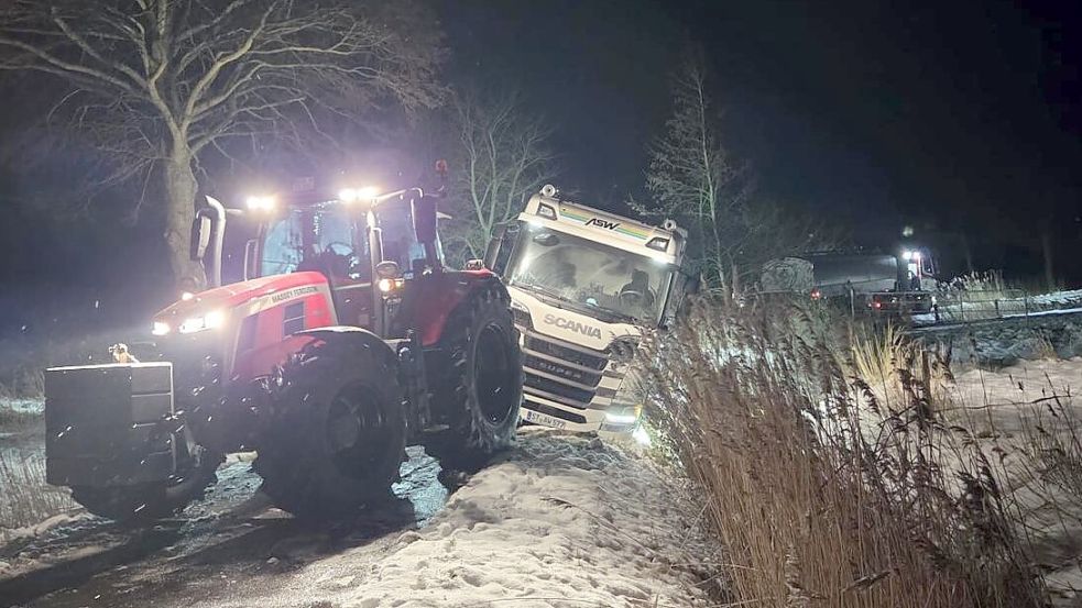 Farmers in winter service: With tractor, snowplow, and rope for the ...